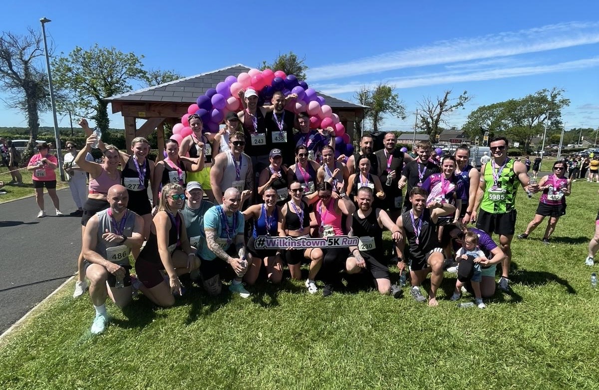 DQ Performance Coaching members celebrating together after a community race